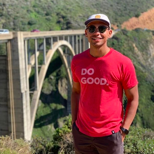 Tyler standing in front of a bridge in California.