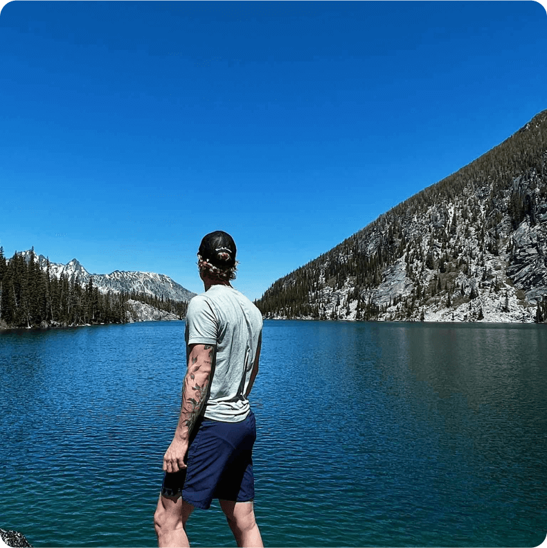 Zac Shepherd overlooking a lake and mountains