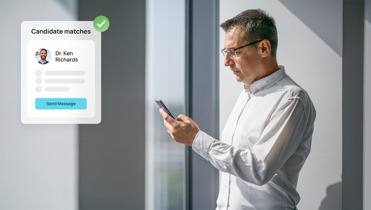 Man by window looking at his phone